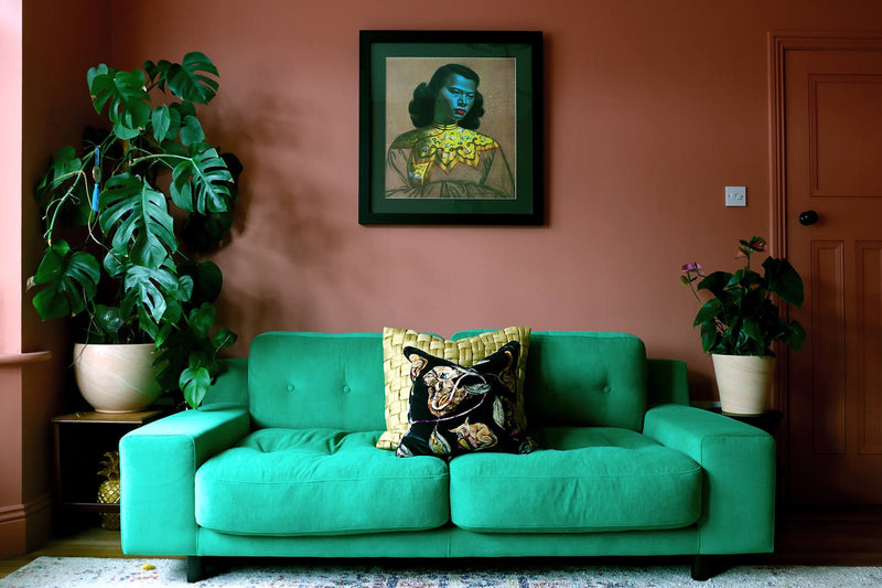 Living room painted in Lick paint Red 03 with complementary jade green coloured sofa