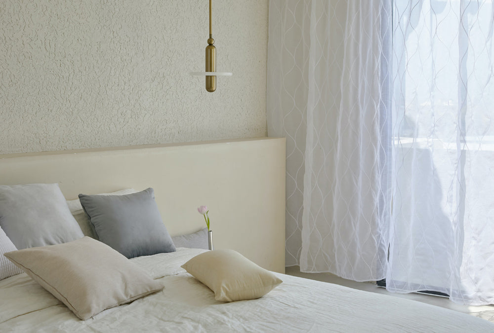 Minimalist bedroom with linen curtains
