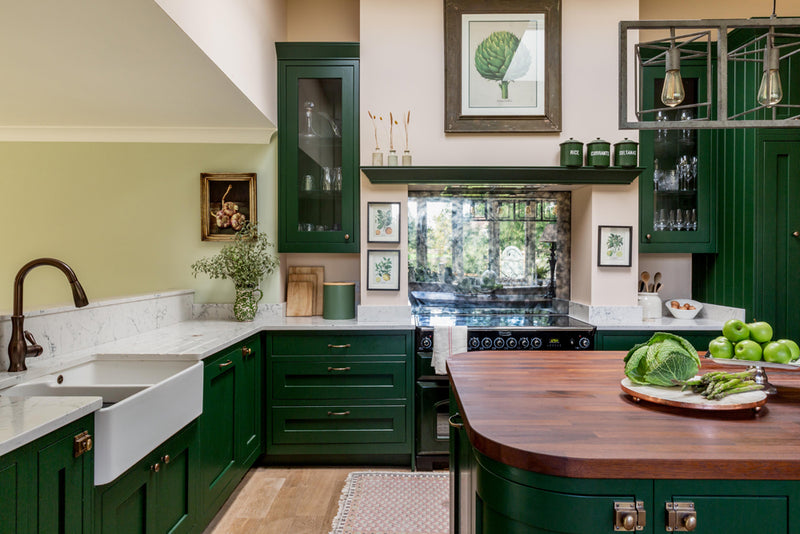 A traditional kitchen with green cabinets