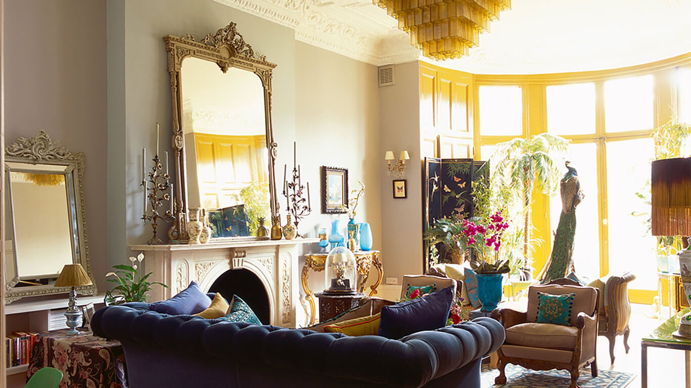 Eclectic living room with blue and gold accents by Mathew Williamson 