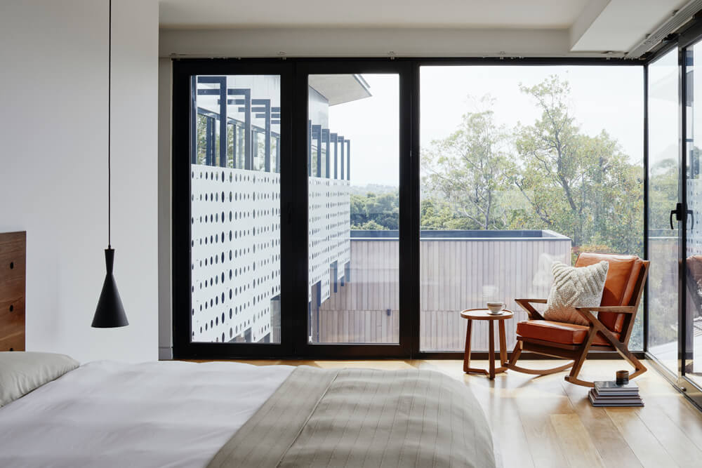 Modern bedroom with large windows