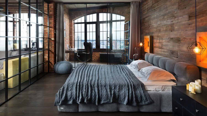 Dark industrial bedroom with orange accents and lighting 